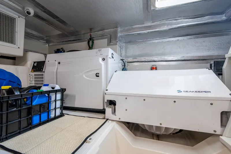 Slide: The Image of Engine room of 2023 Maritimo M55 yacht with Seakeeper stabilizer and storage containers. - 146