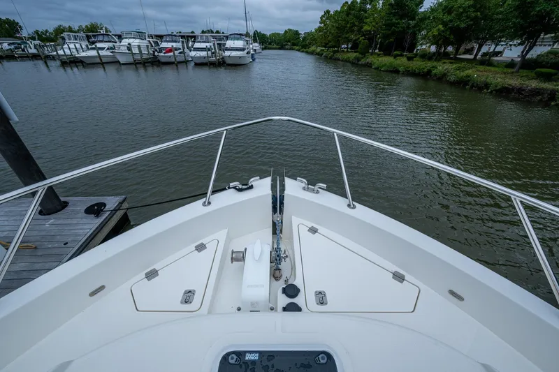Slide: The Image of Bow view of 2023 Maritimo M55 yacht docked in a marina. - 17