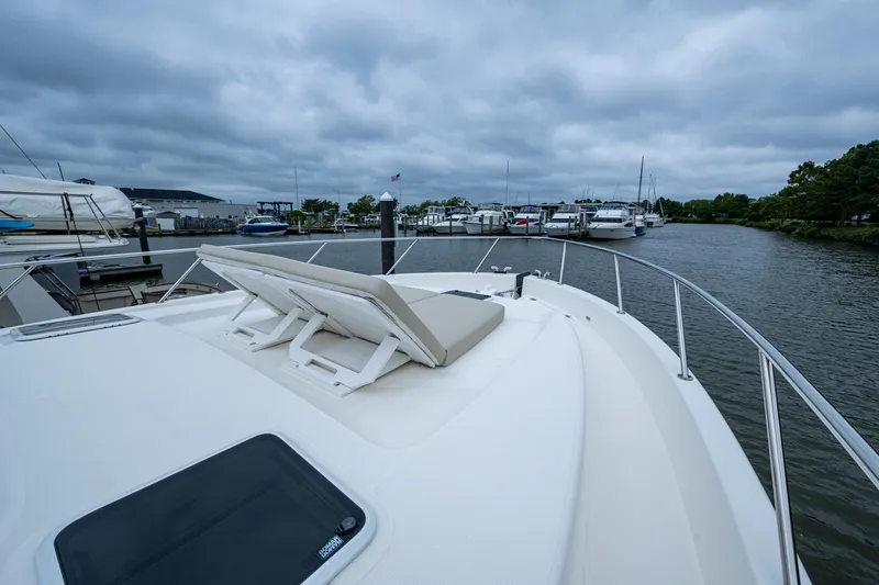 Slide: The Image of 2023 Maritimo M55 yacht docked at marina under cloudy sky. - 19