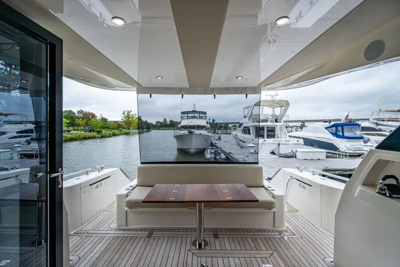 Slide: The Image of 2023 Maritimo M55 yacht interior with docked boats in marina view. - 21