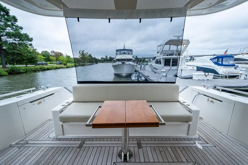 Slide: The Image of 2023 Maritimo M55 yacht interior with seating and table, docked at marina. - 22