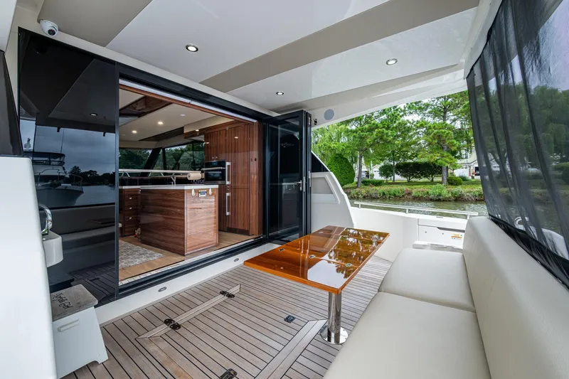 Slide: The Image of Luxurious 2023 Maritimo M55 yacht interior with elegant wood finishes and spacious seating area. - 24