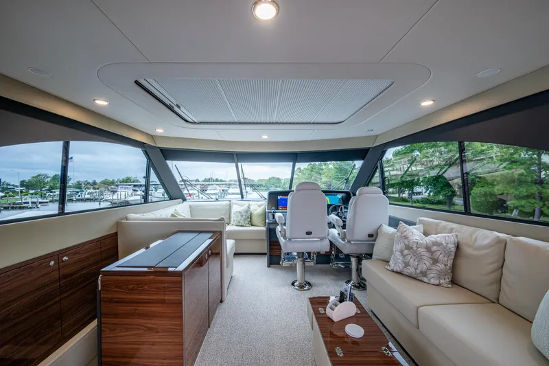 Slide: The Image of Luxurious interior of 2023 Maritimo M55 yacht with modern seating and panoramic windows. - 32