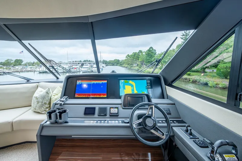 Slide: The Image of 2023 Maritimo M55 yacht helm with navigation screens and steering wheel. - 36