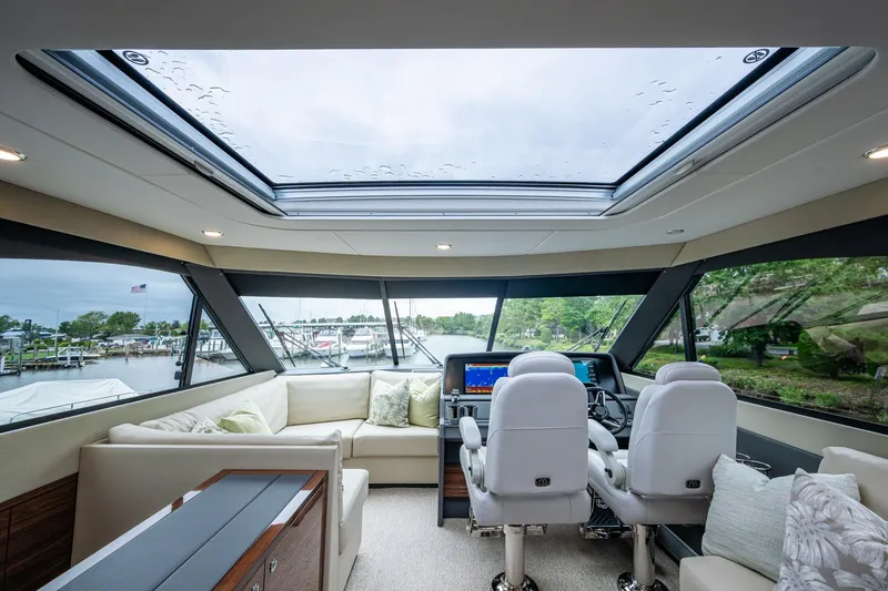 Slide: The Image of Luxurious interior of 2023 Maritimo M55 yacht with panoramic windows and plush seating. - 38