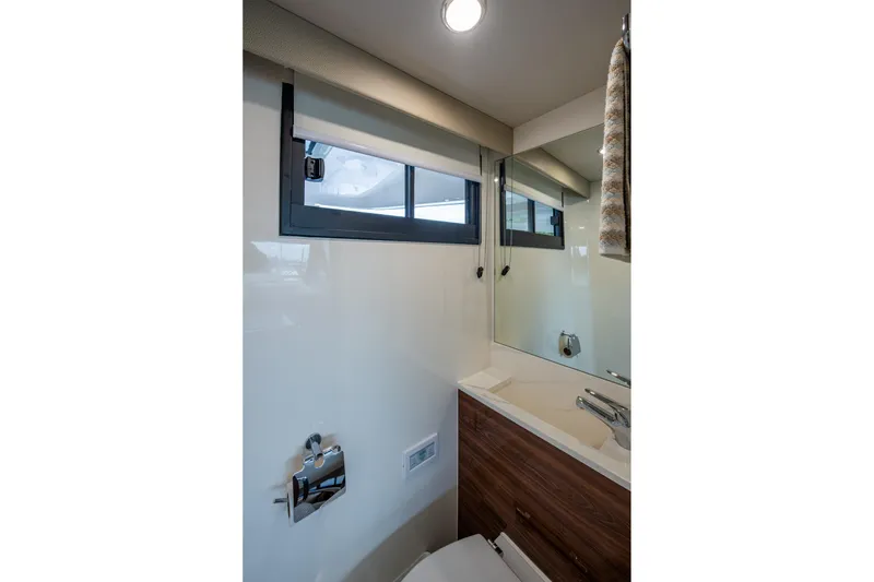 Slide: The Image of Luxurious bathroom interior of 2023 Maritimo M55 yacht with modern fixtures and window. - 43