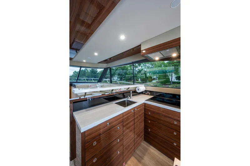 Slide: The Image of Luxurious kitchen interior of 2023 Maritimo M55 yacht with modern wood cabinetry. - 55