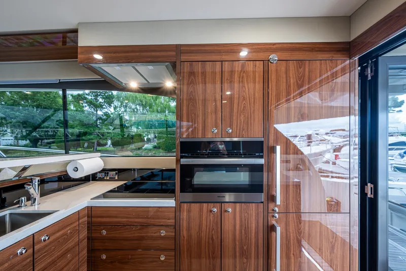 Slide: The Image of Luxurious kitchen interior of 2023 Maritimo M55 yacht with modern appliances and wood finish. - 57