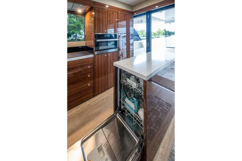 Slide: The Image of Luxurious 2023 Maritimo M55 yacht kitchen with modern appliances and elegant wood cabinetry. - 61
