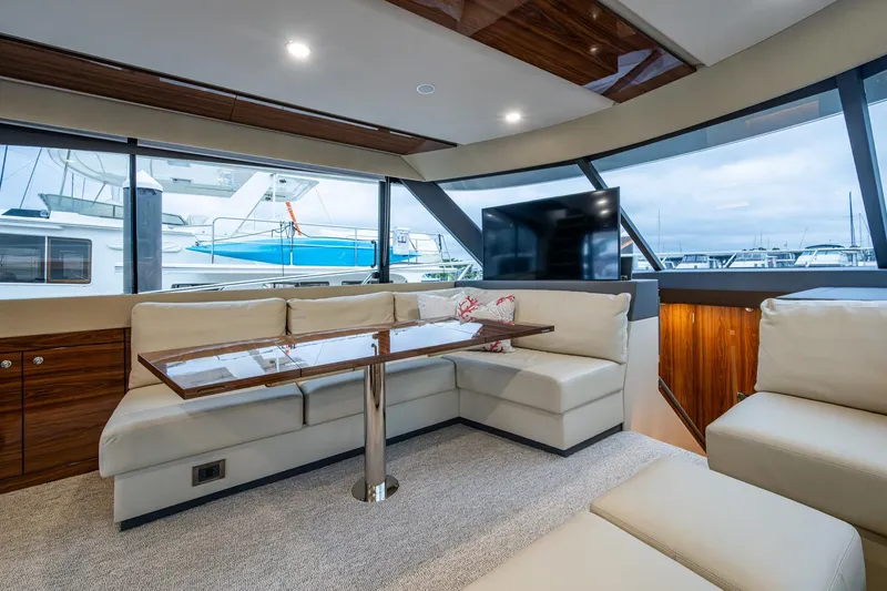 Slide: The Image of Luxurious interior of 2023 Maritimo M55 yacht with plush seating and panoramic windows. - 70