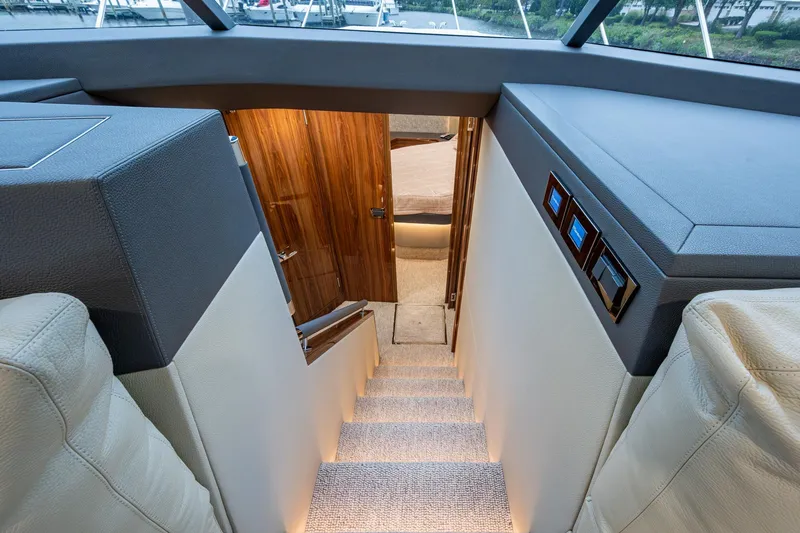 Slide: The Image of Interior view of 2023 Maritimo M55 yacht, featuring elegant stairs and wooden door. - 71