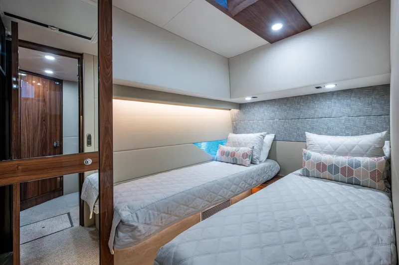 Slide: The Image of Luxurious 2023 Maritimo M55 yacht cabin with twin beds and modern decor. - 75