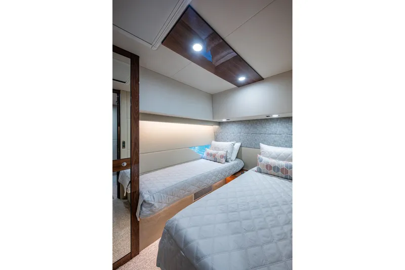 Slide: The Image of Luxurious twin bedroom in 2023 Maritimo M55 yacht, featuring modern design and ambient lighting. - 76