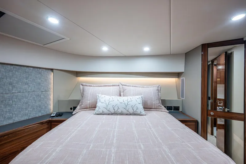 Slide: The Image of Luxurious bedroom interior of 2023 Maritimo M55 yacht with elegant bedding and modern lighting. - 81