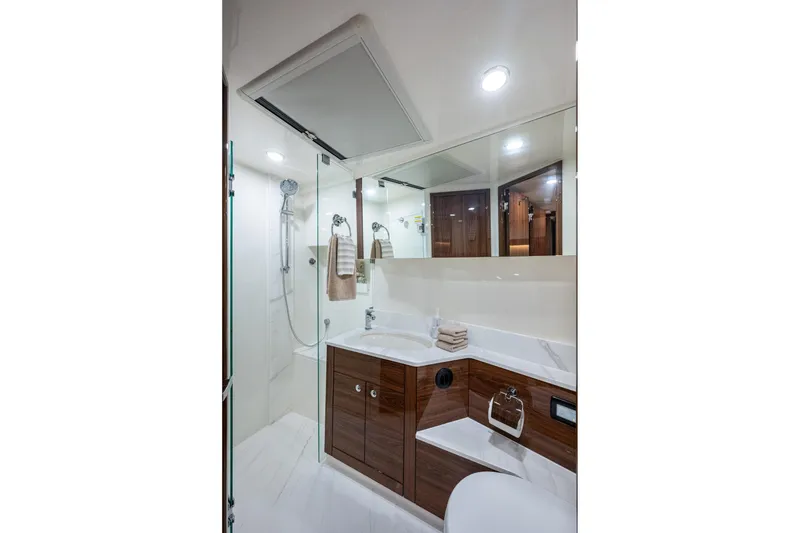 Slide: The Image of Luxurious bathroom in 2023 Maritimo M55 yacht with modern fixtures and elegant wood cabinetry. - 83