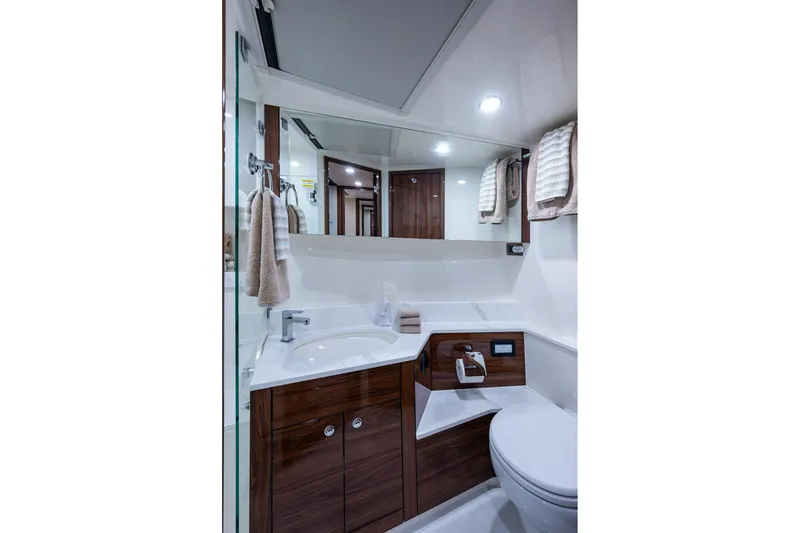 Slide: The Image of Luxurious bathroom in 2023 Maritimo M55 yacht with modern fixtures and elegant wood accents. - 86