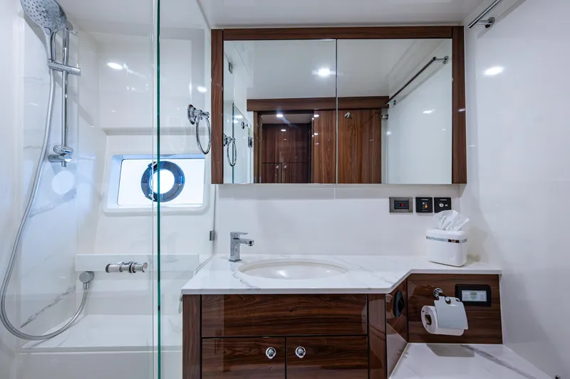 Slide: The Image of Luxurious bathroom in 2023 Maritimo M55 yacht with modern fixtures and elegant wood accents. - 87