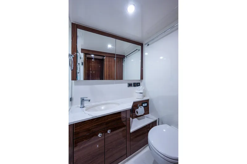 Slide: The Image of Luxurious bathroom in 2023 Maritimo M55 yacht with modern fixtures and elegant wood accents. - 88