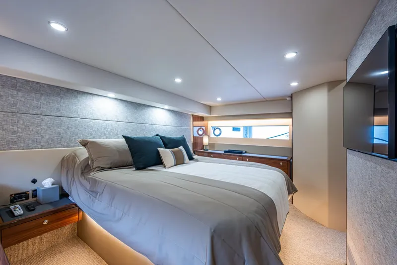 Slide: The Image of Luxurious bedroom interior of 2023 Maritimo M55 yacht, featuring elegant bedding and modern lighting. - 99