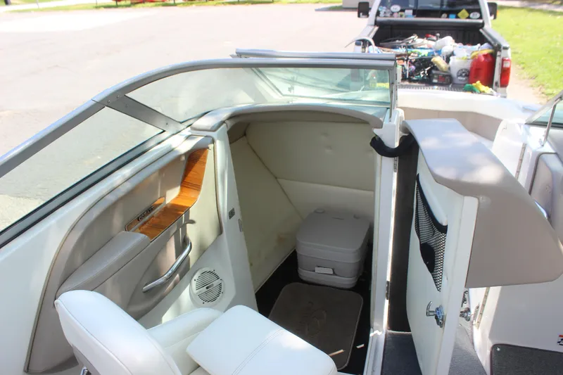 Slide: The Image of 2006 Cobalt 246 boat interior with seating and storage compartment. - 2