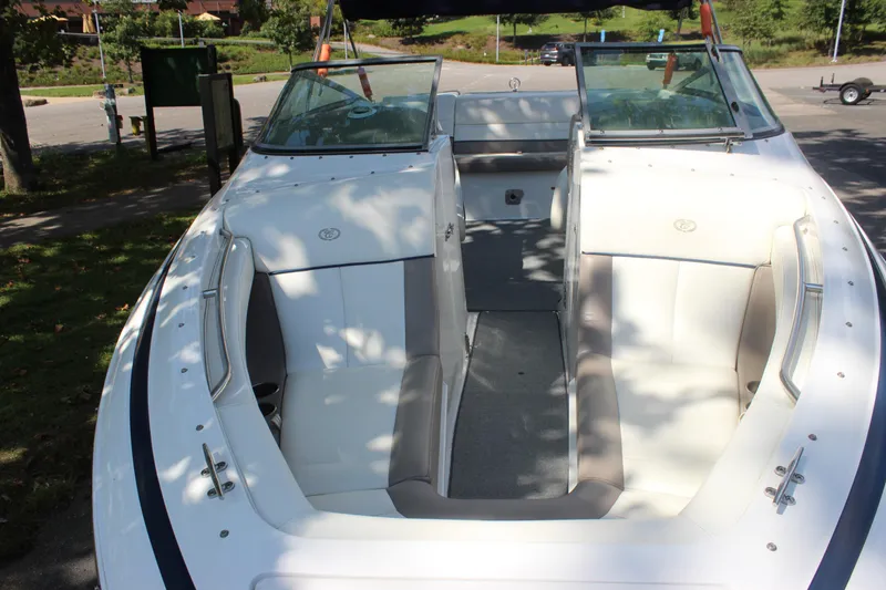 Slide: The Image of 2006 Cobalt 246 boat interior with white seating and open bow design. - 22