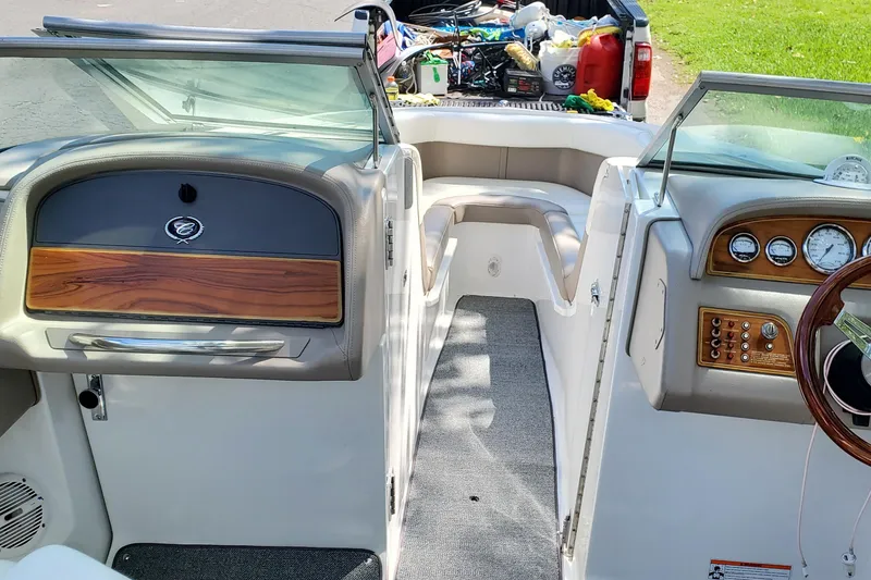 Slide: The Image of Interior view of a 2006 Cobalt 246 boat with dashboard and seating area. - 29