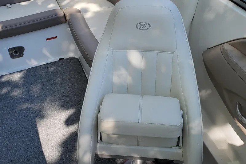 Slide: The Image of 2006 Cobalt 246 boat interior with white leather seating and gray carpet. - 32