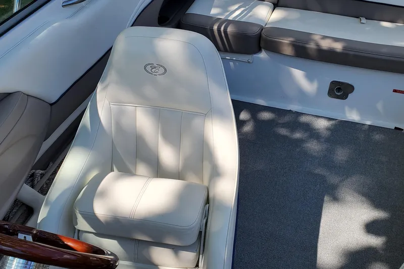 Slide: The Image of Interior of a 2006 Cobalt 246 boat with white seating and carpet flooring. - 33