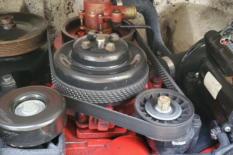 Slide: The Image of Close-up of a 2006 Cobalt 246 engine belt system with pulleys and components. - 44