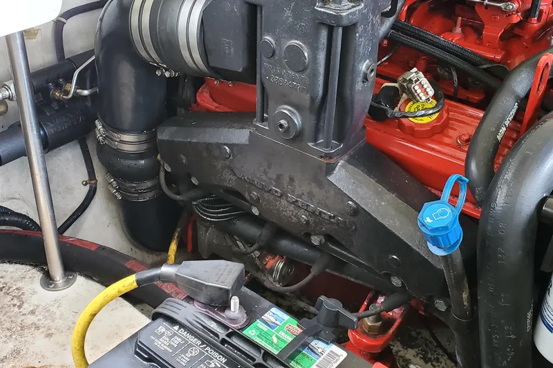 Slide: The Image of Engine compartment of a 2006 Cobalt 246 boat, featuring hoses and battery. - 46