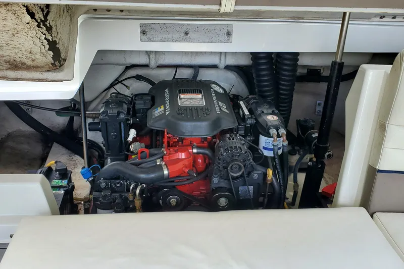 Slide: The Image of 2006 Cobalt 246 boat engine compartment with visible components and wiring. - 48