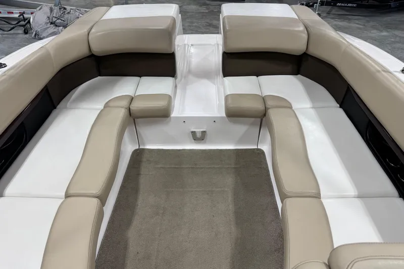 Slide: The Image of 2012 Regal 2700 Bowrider interior with beige and white seating, gray carpet. - 11