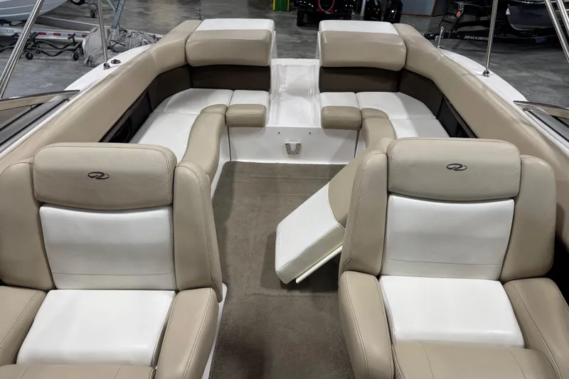 Slide: The Image of 2012 Regal 2700 Bowrider interior with beige and white seating, spacious layout. - 12