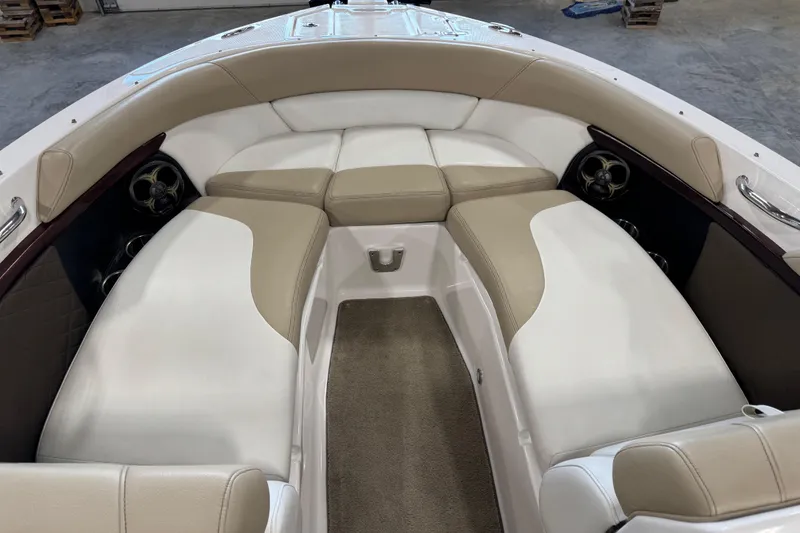 Slide: The Image of 2012 Regal 2700 Bowrider interior with beige and white seating, spacious and comfortable design. - 13