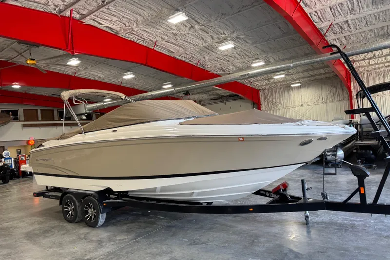 Slide: The Image of 2012 Regal 2700 Bowrider boat on trailer in indoor storage facility. - 17