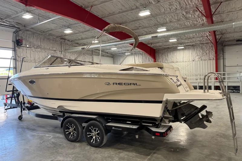Slide: The Image of 2012 Regal 2700 Bowrider boat in a spacious indoor storage facility. - 3