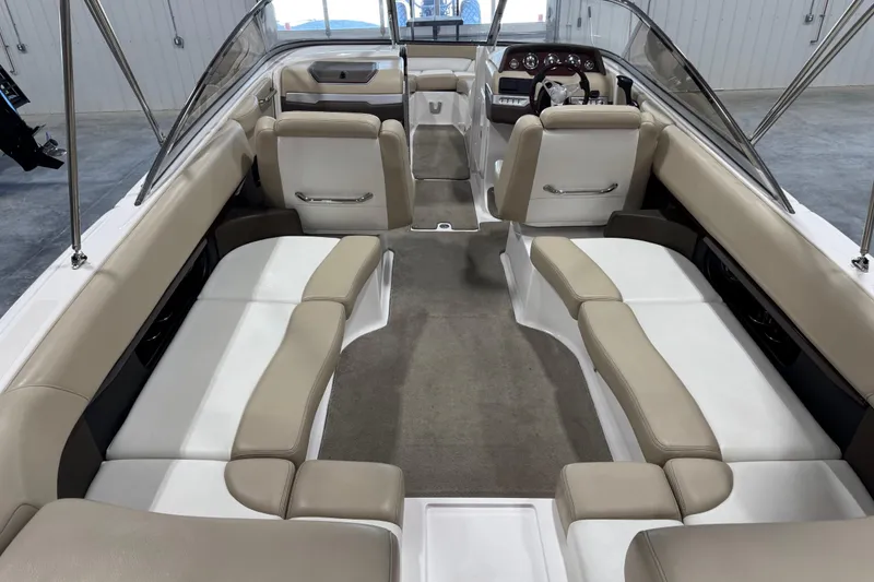 Slide: The Image of 2012 Regal 2700 Bowrider interior with beige and white seating, spacious layout. - 6