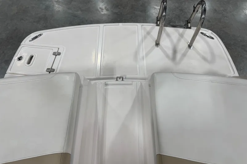 Slide: The Image of 2012 Regal 2700 Bowrider boat deck with swim ladder and storage compartment. - 7