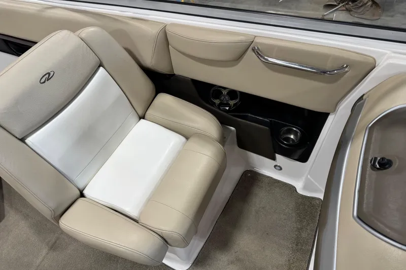 Slide: The Image of 2012 Regal 2700 Bowrider interior with beige seating and cup holder. - 9