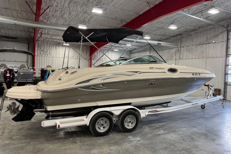 Slide: The Image of 2005 Sea Ray 240 Sundeck boat on trailer in indoor storage facility. - 3