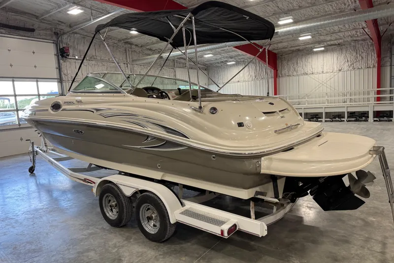 Slide: The Image of 2005 Sea Ray 240 Sundeck boat on trailer in indoor storage facility. - 4