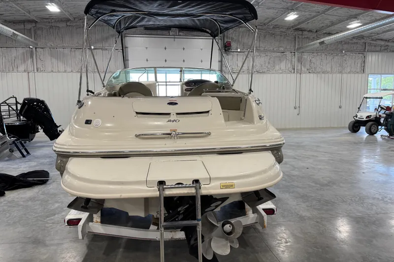 Slide: The Image of 2005 Sea Ray 240 Sundeck boat in a spacious indoor storage facility. - 5