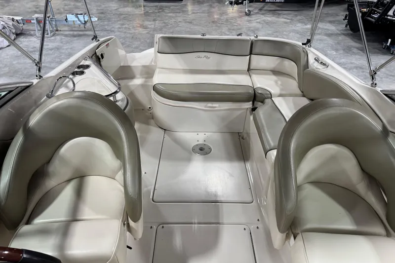 Slide: The Image of 2005 Sea Ray 240 Sundeck interior with beige seating and spacious layout. - 7