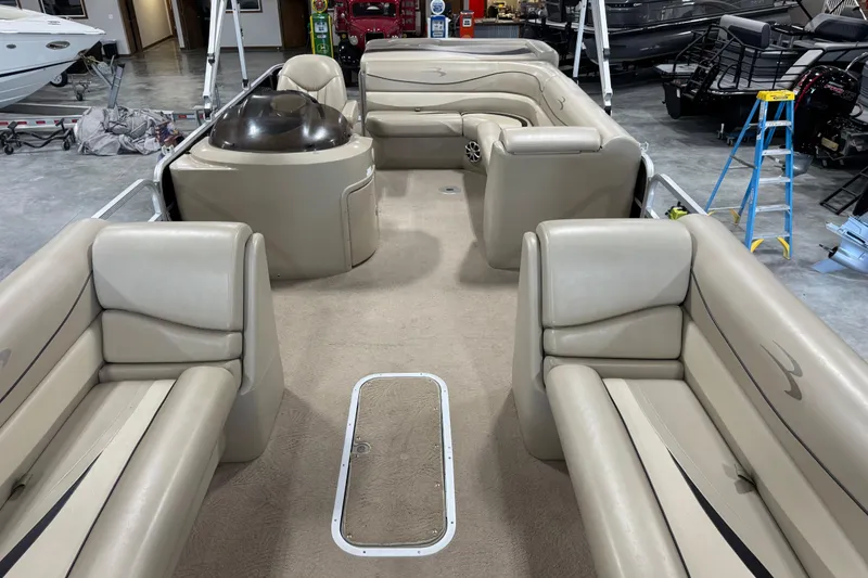 Slide: The Image of 2010 Bennington 2574GLi pontoon boat interior with beige seating and carpet. - 12