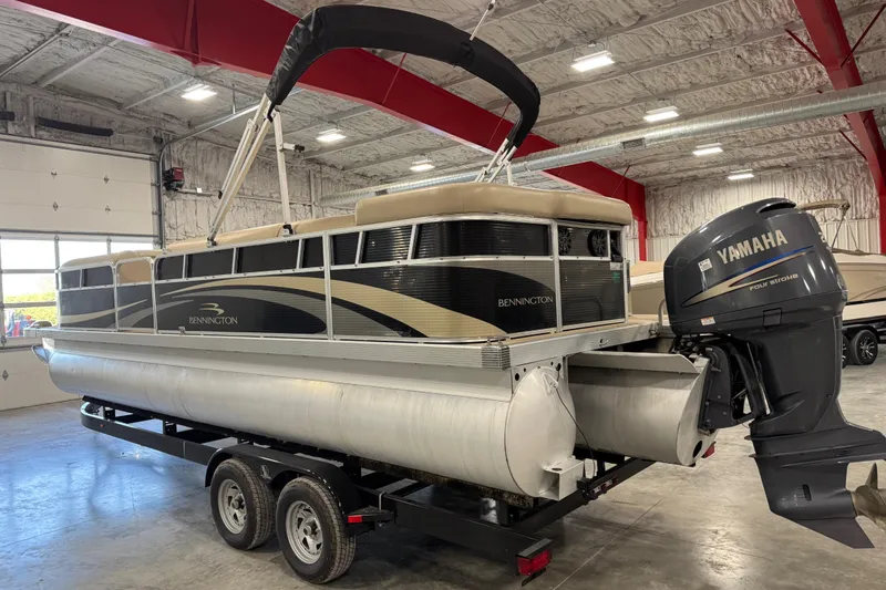 Slide: The Image of 2010 Bennington 2574GLi pontoon boat with Yamaha engine in indoor storage. - 4