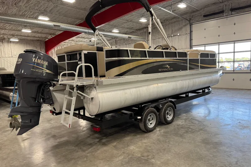 Slide: The Image of 2010 Bennington 2574GLi pontoon boat with Yamaha motor in a spacious garage. - 7