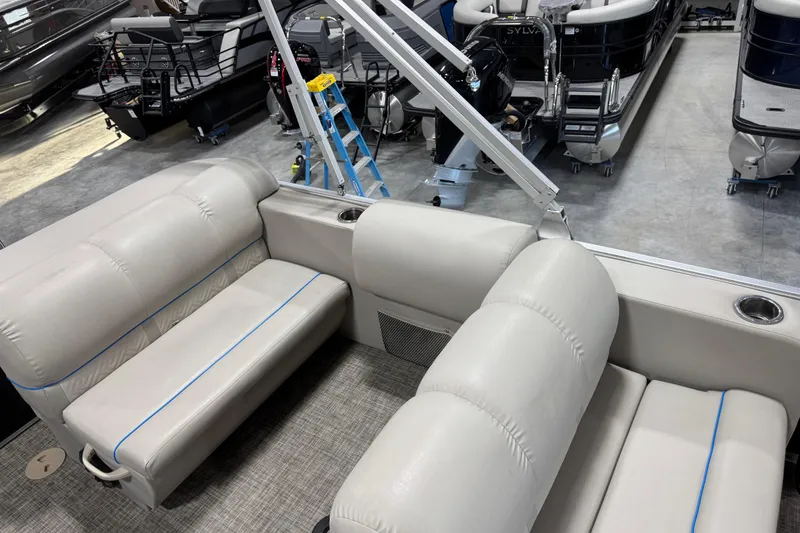 Slide: The Image of 2017 Cypress Cay Seabreeze 253 pontoon boat interior with beige seating and cup holders. - 11