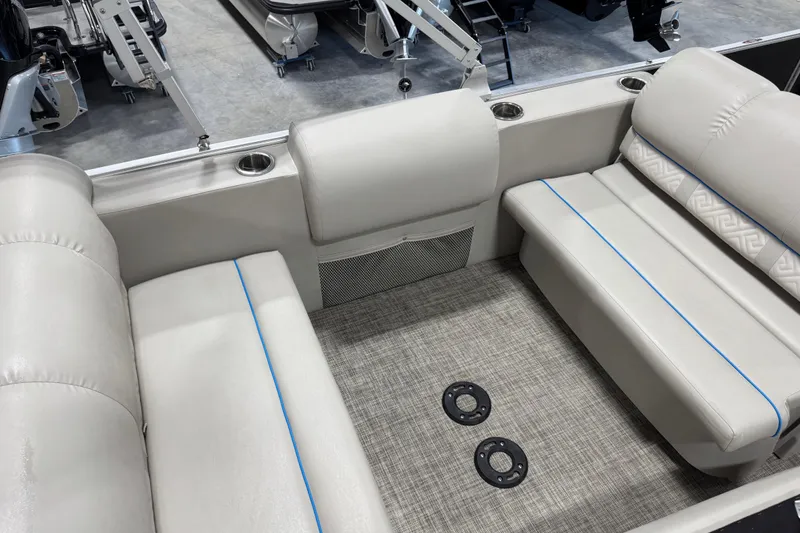 Slide: The Image of 2017 Cypress Cay Seabreeze 253 interior with beige seating, cup holders, and textured flooring. - 12