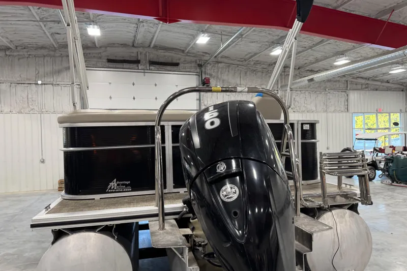 Slide: The Image of 2017 Cypress Cay Seabreeze 253 pontoon boat with 150 HP engine in a warehouse. - 6