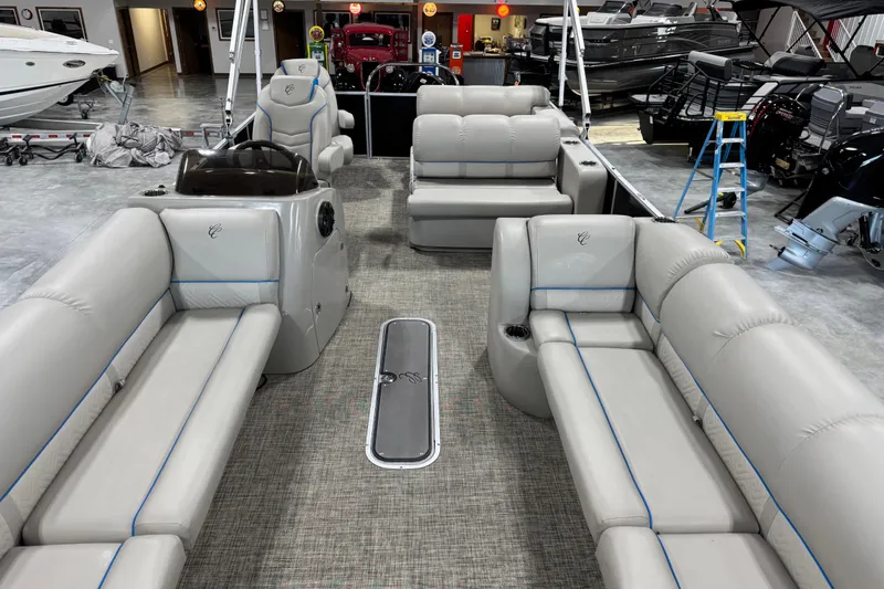 Slide: The Image of 2017 Cypress Cay Seabreeze 253 pontoon boat interior with plush seating in showroom. - 8